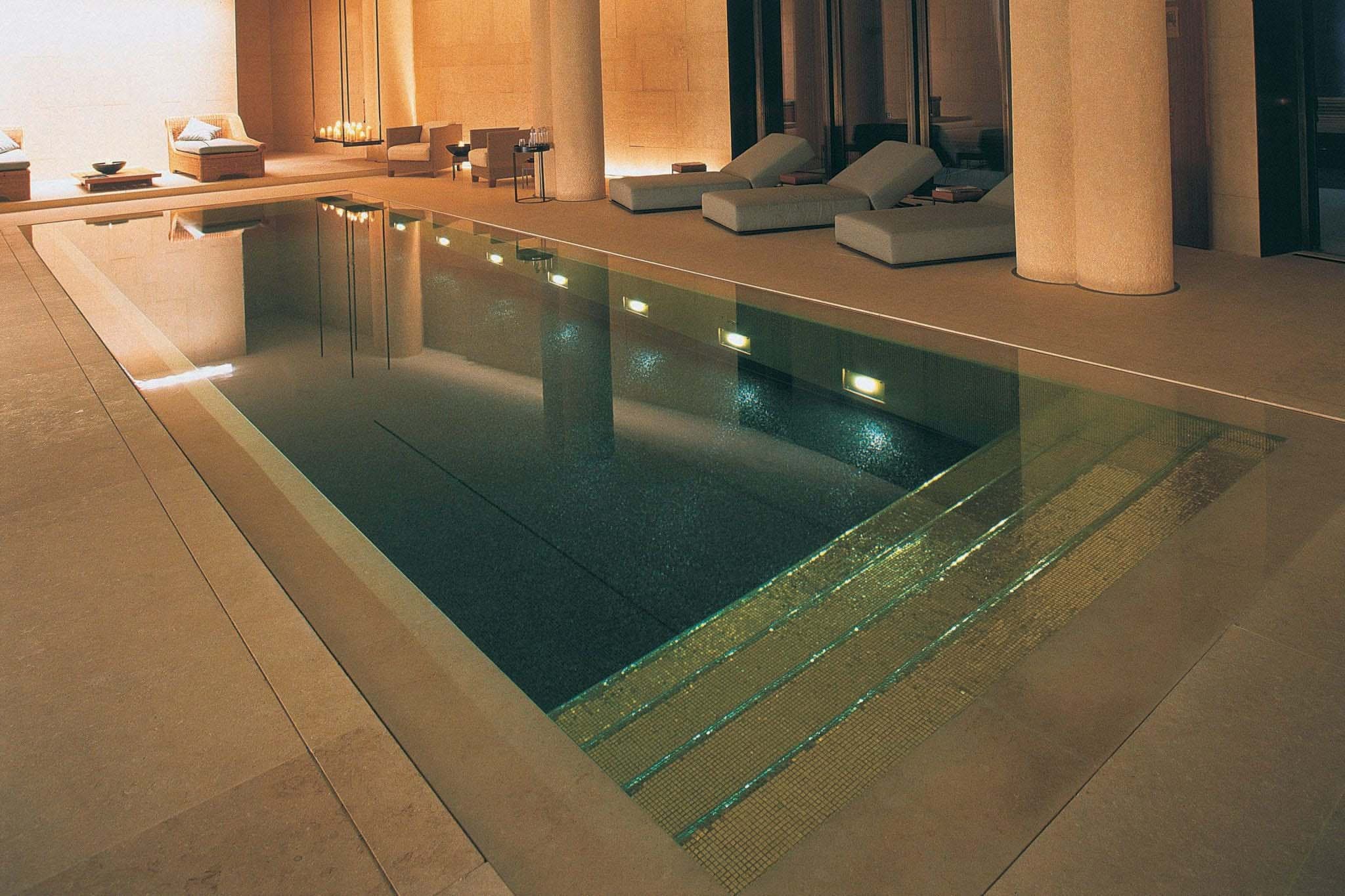 Elegant minimalist pool with dark mosaic tiles and ambient lighting