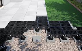 Outdoor deck installation showing NuraGrid with pavers and artificial turf integration